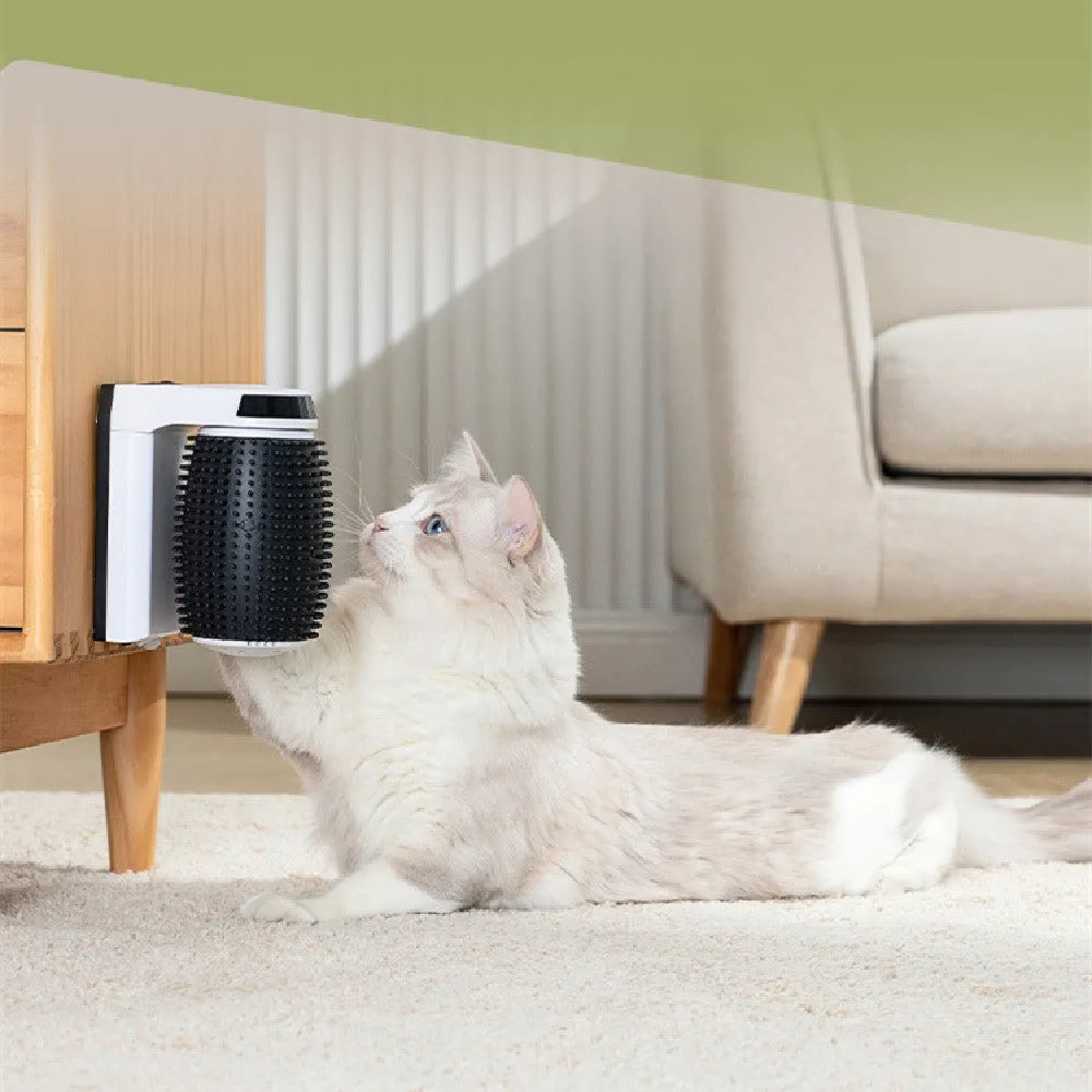 White automatic cat self-groomer brush mounted in a wall corner with soft silicone bristles.