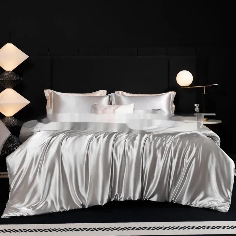 Silk four-piece bed sheet set in a solid colour on a bed, showing modern simplicity style.