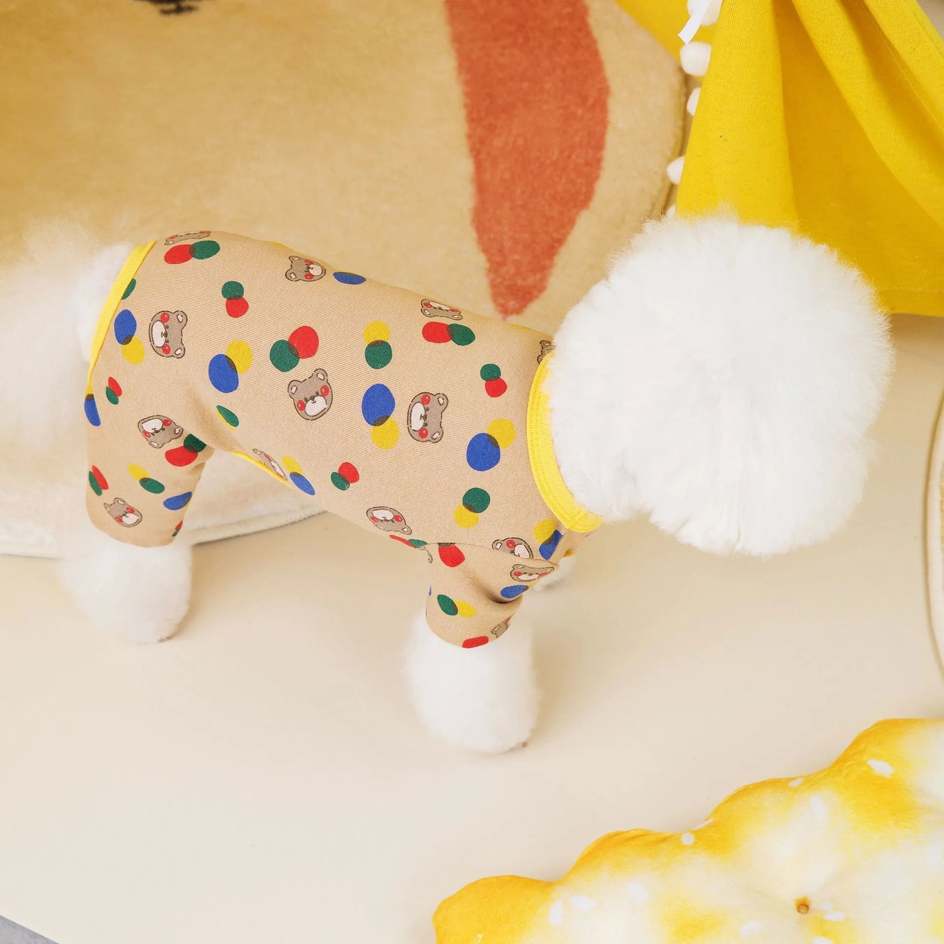 Beige dog t-shirt with a colourful cartoon bear print, showing a casual fit on a pet.