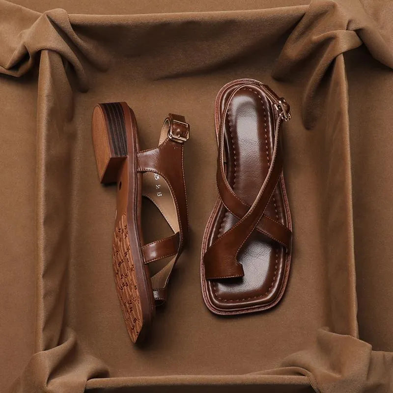 French retro brown toe ring sandals with square toe and ankle-strap buckle on a neutral background