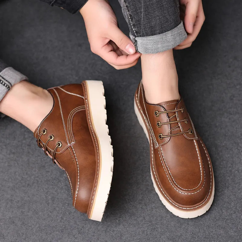 Men's black retro low-top casual boots with round toe and rubber sole on a neutral background.