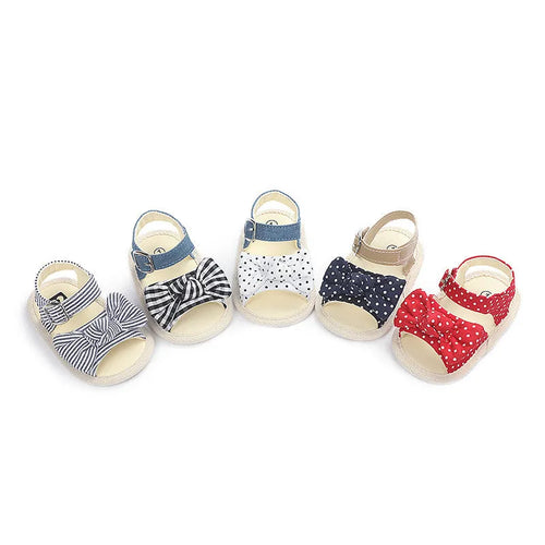 White and black Velcro baby toddler shoes for ages 0-18 months, showing low tube height design.