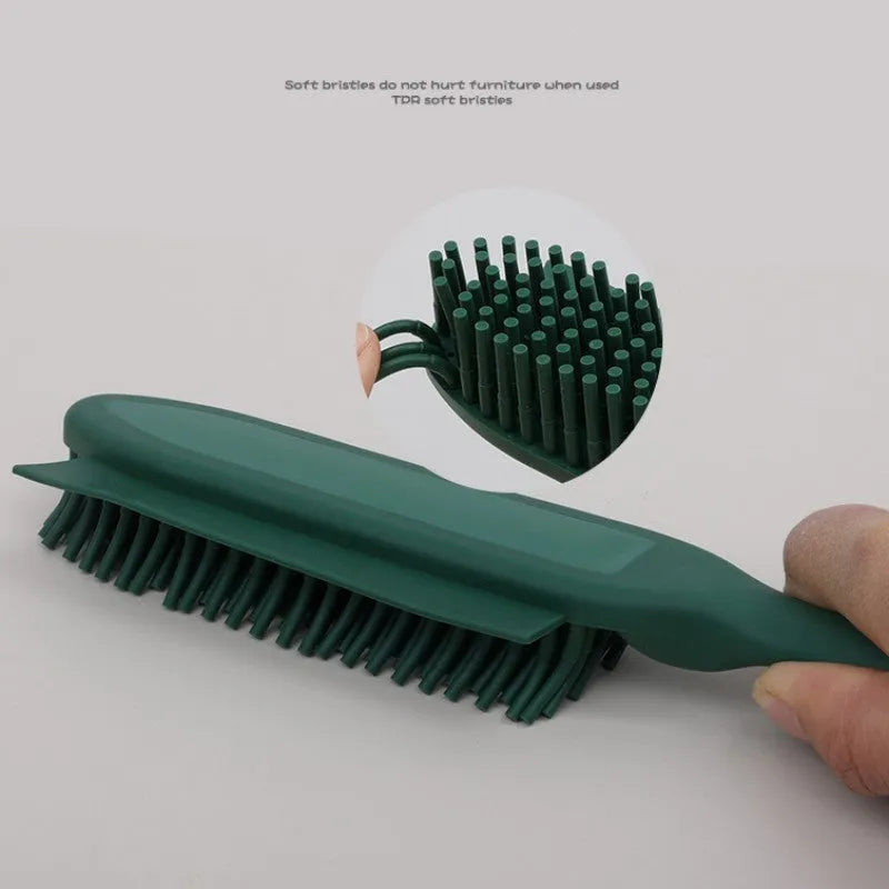 Pink and green handheld pet hair remover brush with grooming comb and integrated clothes hair collector.