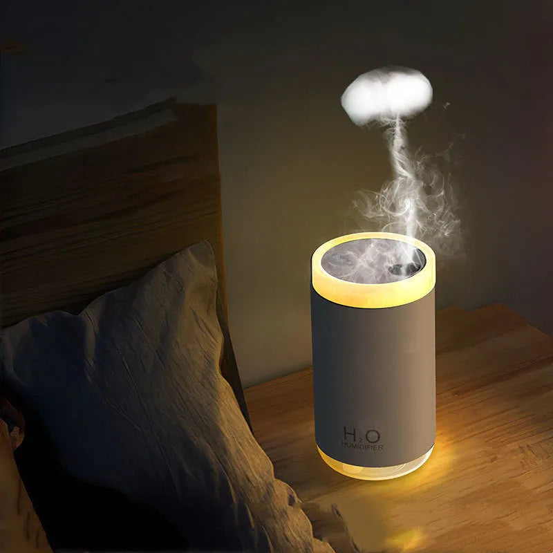 White portable USB humidifier with jellyfish mist spray and warm night light on wooden surface