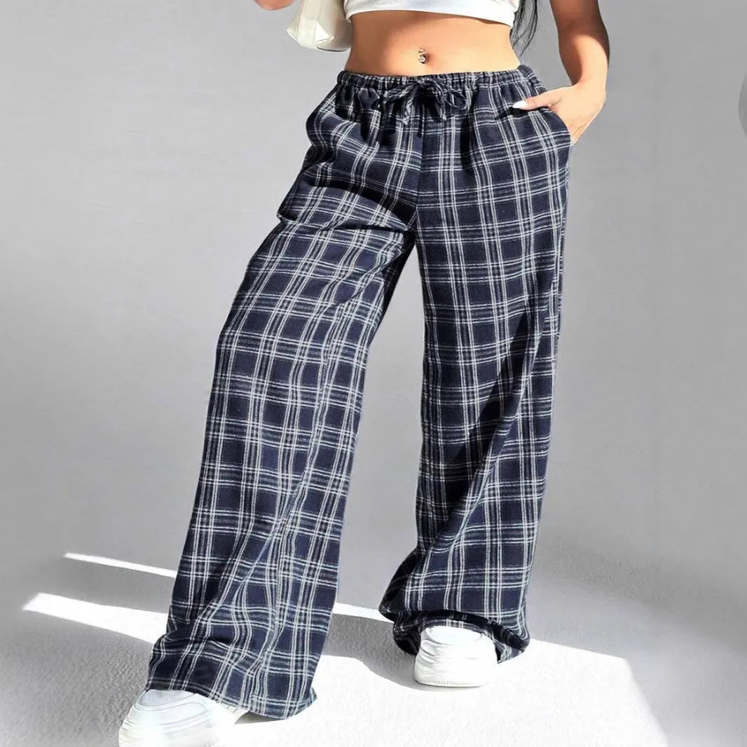 Blue plaid women's casual trousers with drawstring waist and pockets on a hanger.