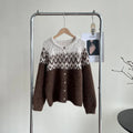 Woman wearing a loose-fit brown jacquard sweater coat with long sleeves.