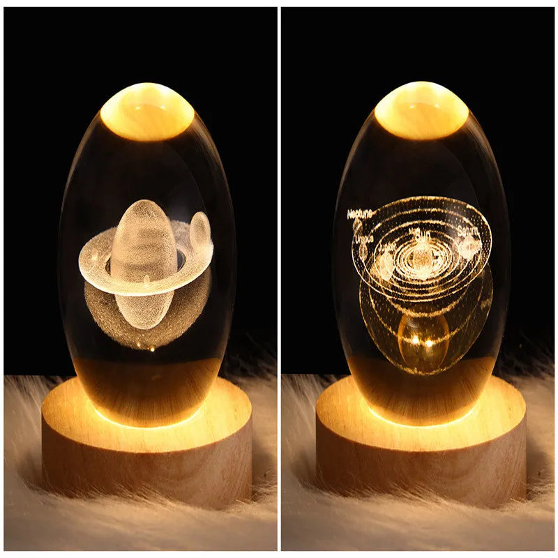 LED galaxy crystal ball night light with 3D planet designs on a table