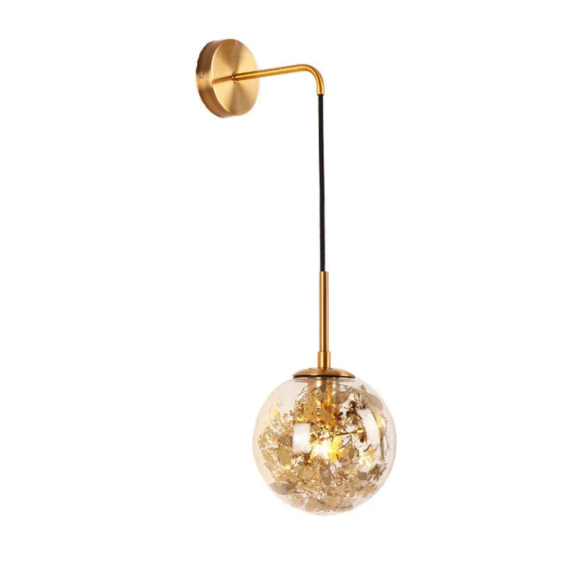 Modern simple glass bedside wall lamp in silver or gold finish on a white wall.
