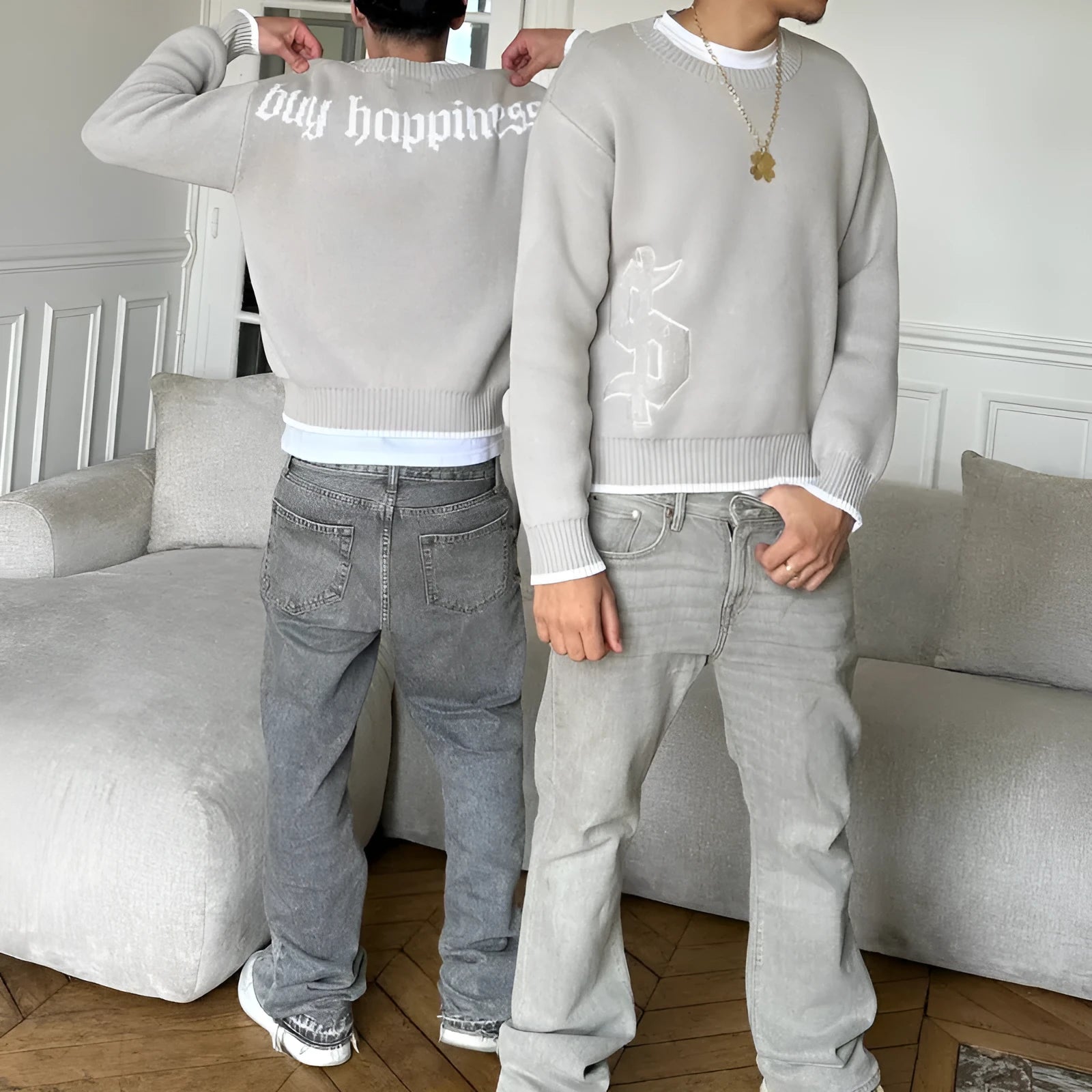 Grey loose-fitting jacquard knitwear coat with long sleeves on a hanger.