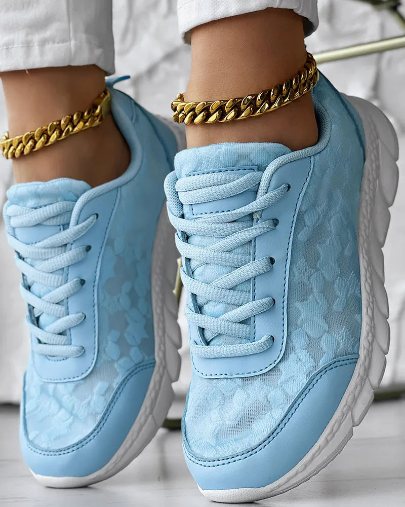 Women's white canvas casual running shoes with a soft sole and round toe on a plain background.
