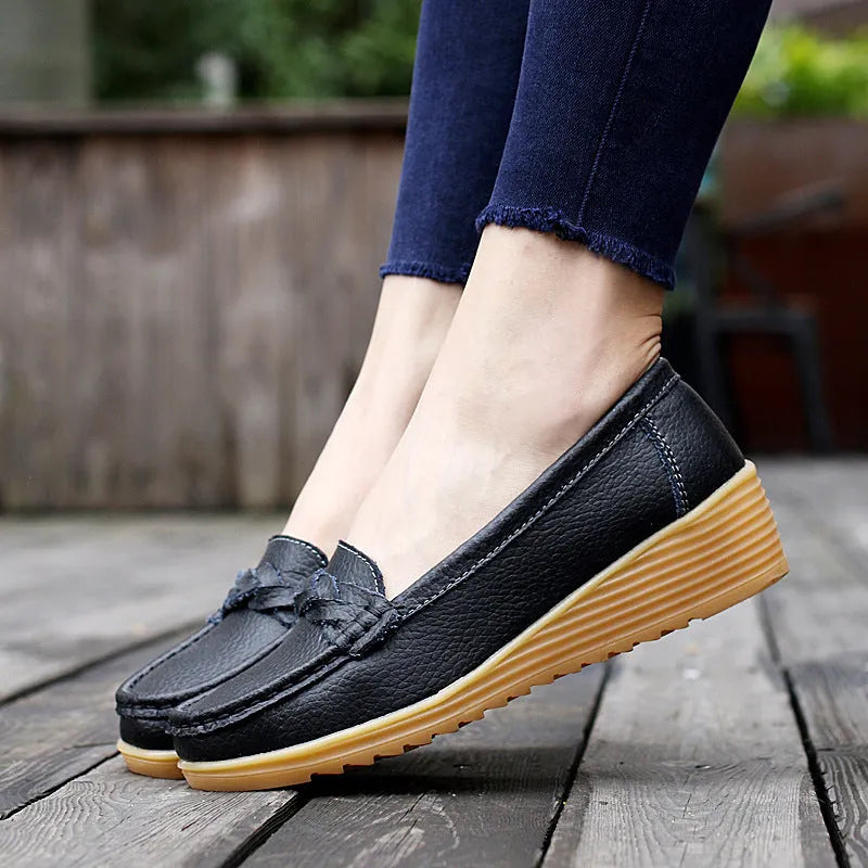 Women's cowhide Gommino soft bottom wedge heels in round toe style with genuine leather upper on display
