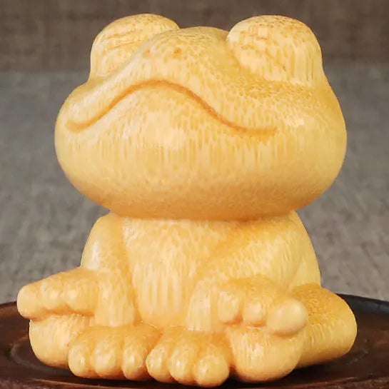 Solid bamboo smiling frog carving ornament measuring 5cm high with cartoon design