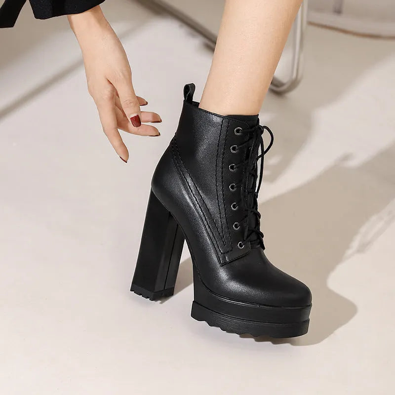 Women's black chunky heel waterproof ankle boots with a side zip on a white background.