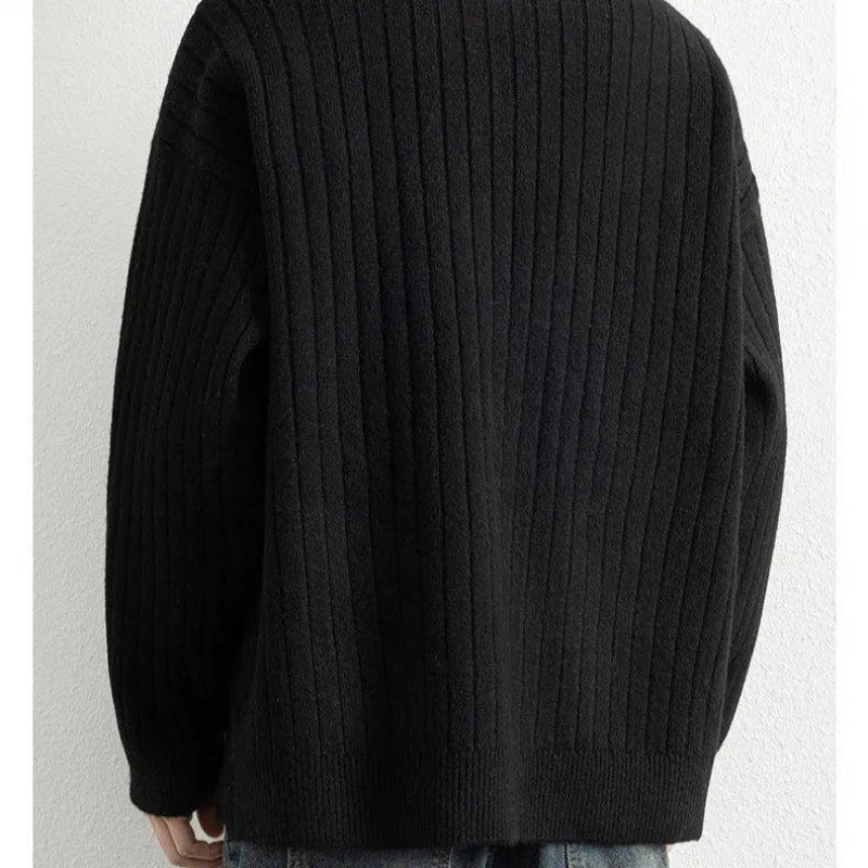A grey men's loose fit half zip pullover sweater with a textured knit and long sleeves.