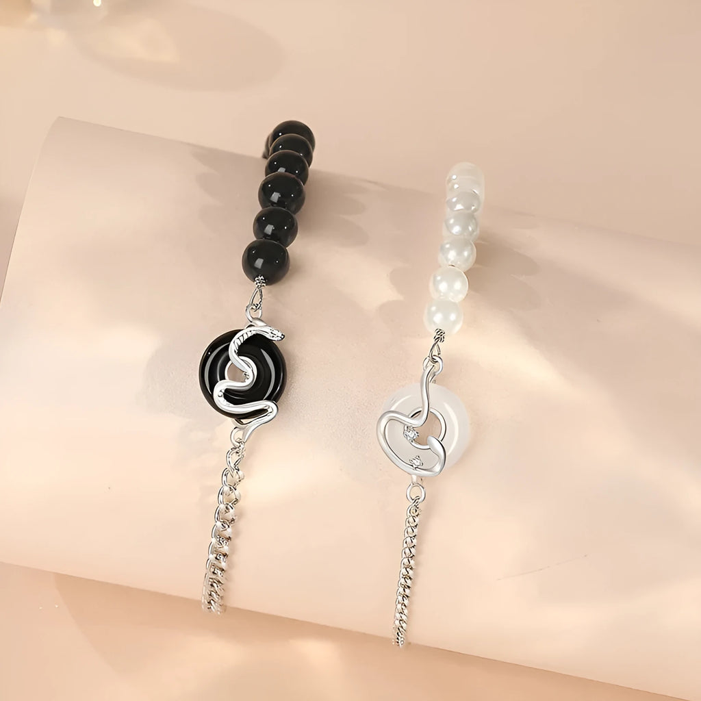 Close-up of a 925 sterling silver bracelet with a snake design, obsidian pearl, and a safe buckle clasp.