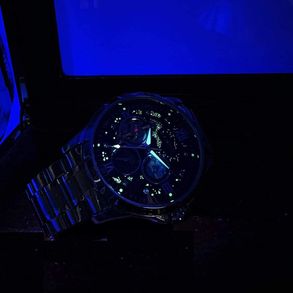 Automatic mechanical men's watch with rose gold case and black dial on wrist.