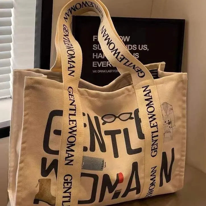 Canvas tote bag with printed design, available in black letters, coloured letters, and pattern style options.