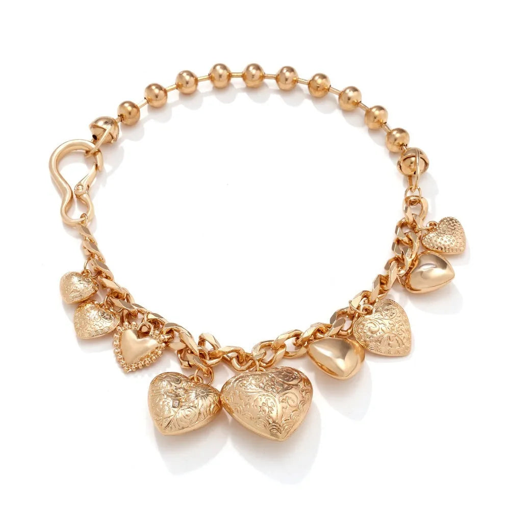 Exaggerated style gold heart pendant necklace with a regular chain on a plain background.