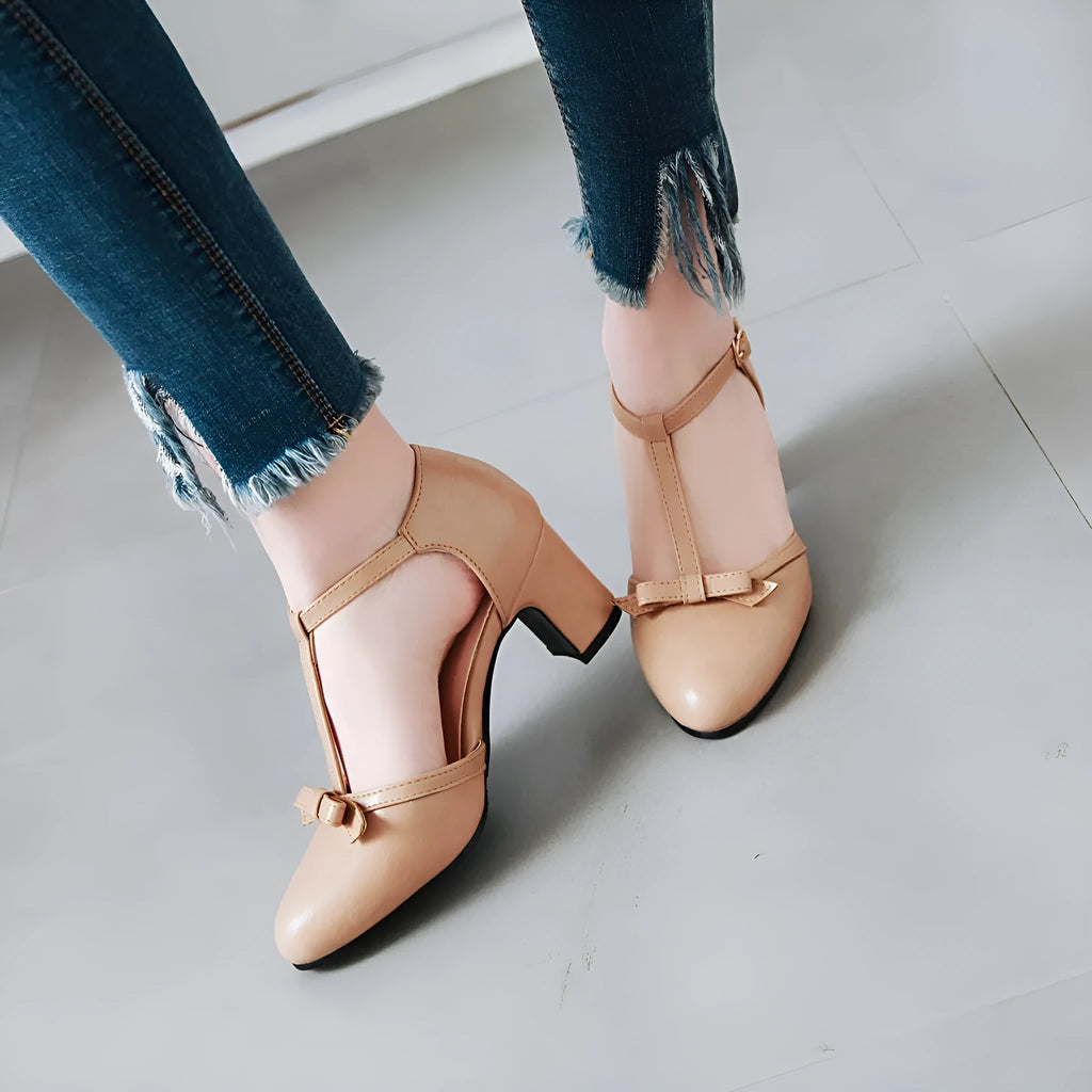 Women's apricot chunky heel sandals with a buckle strap and bow detail on a hollow-out PU upper.