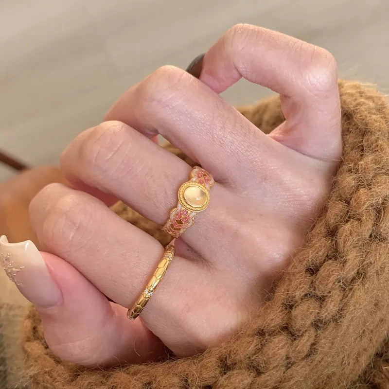 Women's geometric open ring with pink crystal enamel finish on adjustable copper gold plating