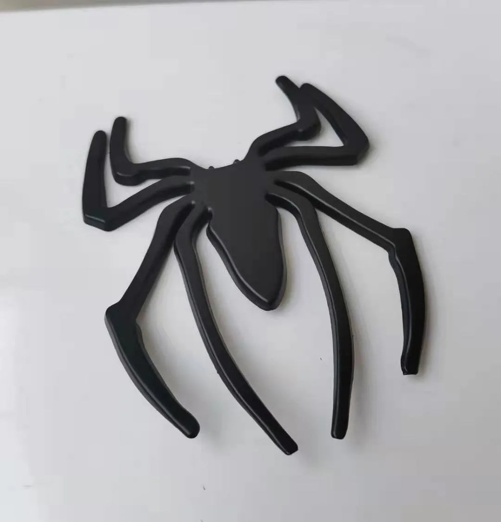 Zinc alloy 3D spider car bumper sticker in gold, silver, black, and red colours.