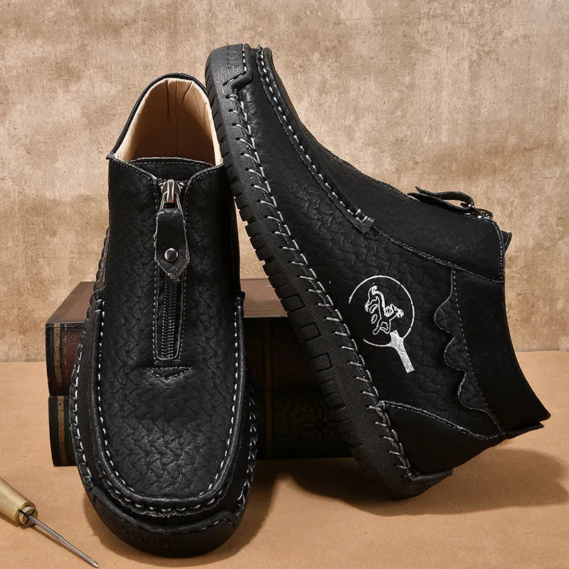 Men's black slip-on leather loafers with a round toe and low flat heel on a rubber sole.