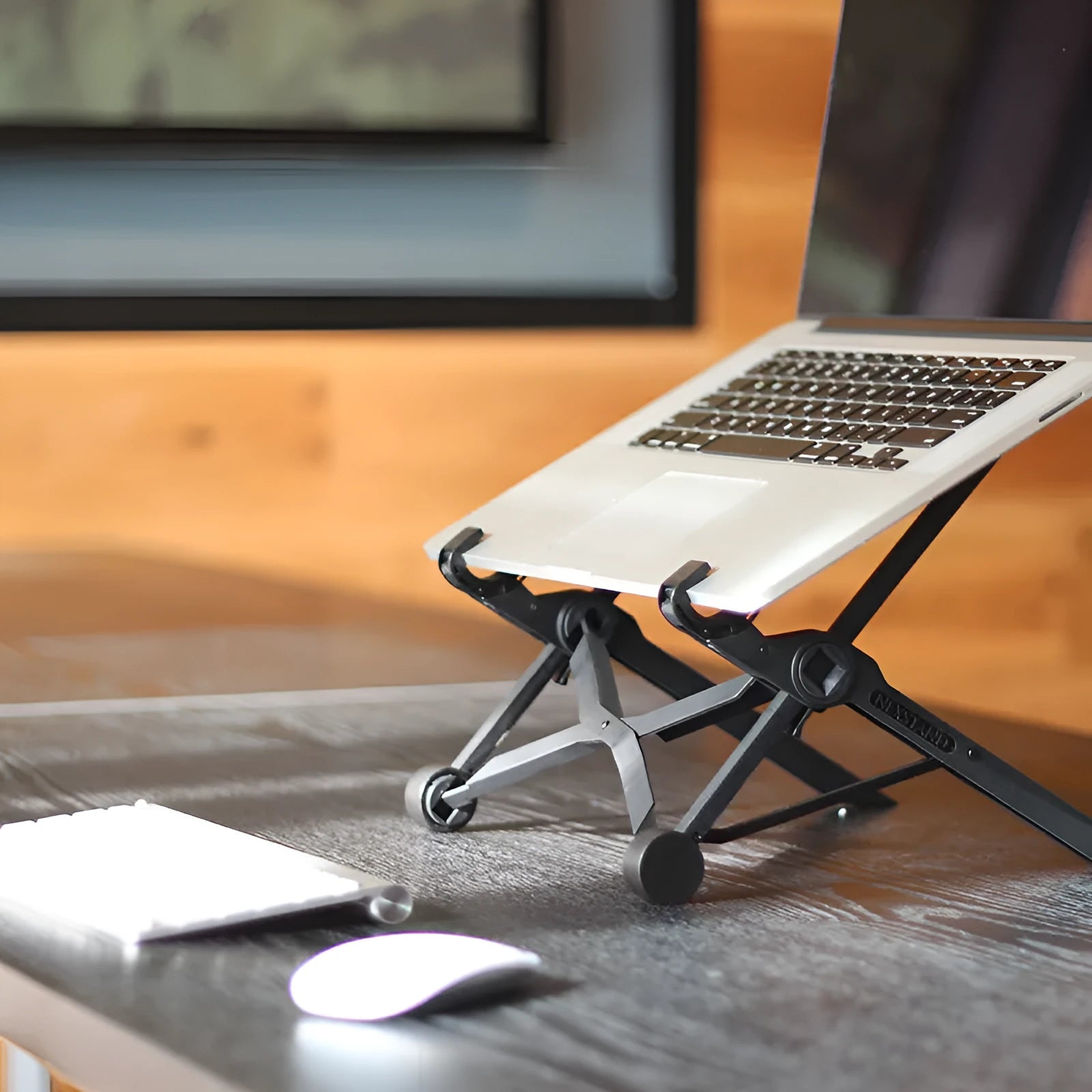 Black foldable laptop stand with height adjustment and protective nylon carrying case