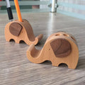 A decorative resin mobile phone stand holding a smartphone, shown in an animal design variant.