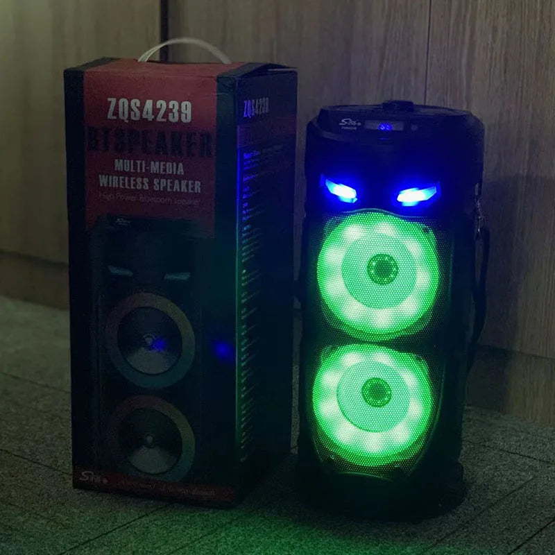 Black portable Bluetooth speaker with dual horn design and wheat detailing, showing USB port and card slot