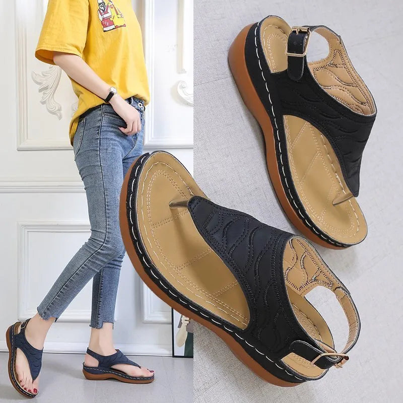 Women's black casual wedge heel sandals with an adjustable buckle strap on ankle.