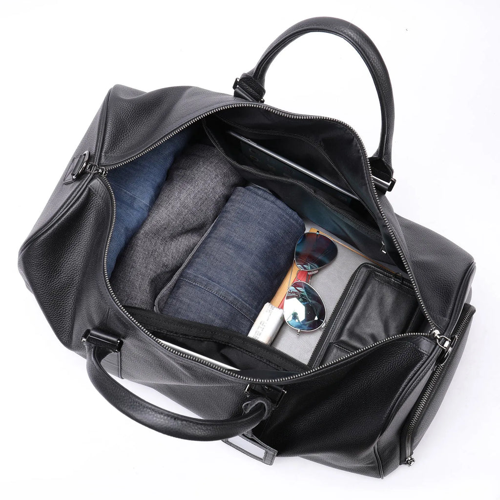 Men's black leather excursion tote bag with single shoulder strap shown alongside coffee brown version