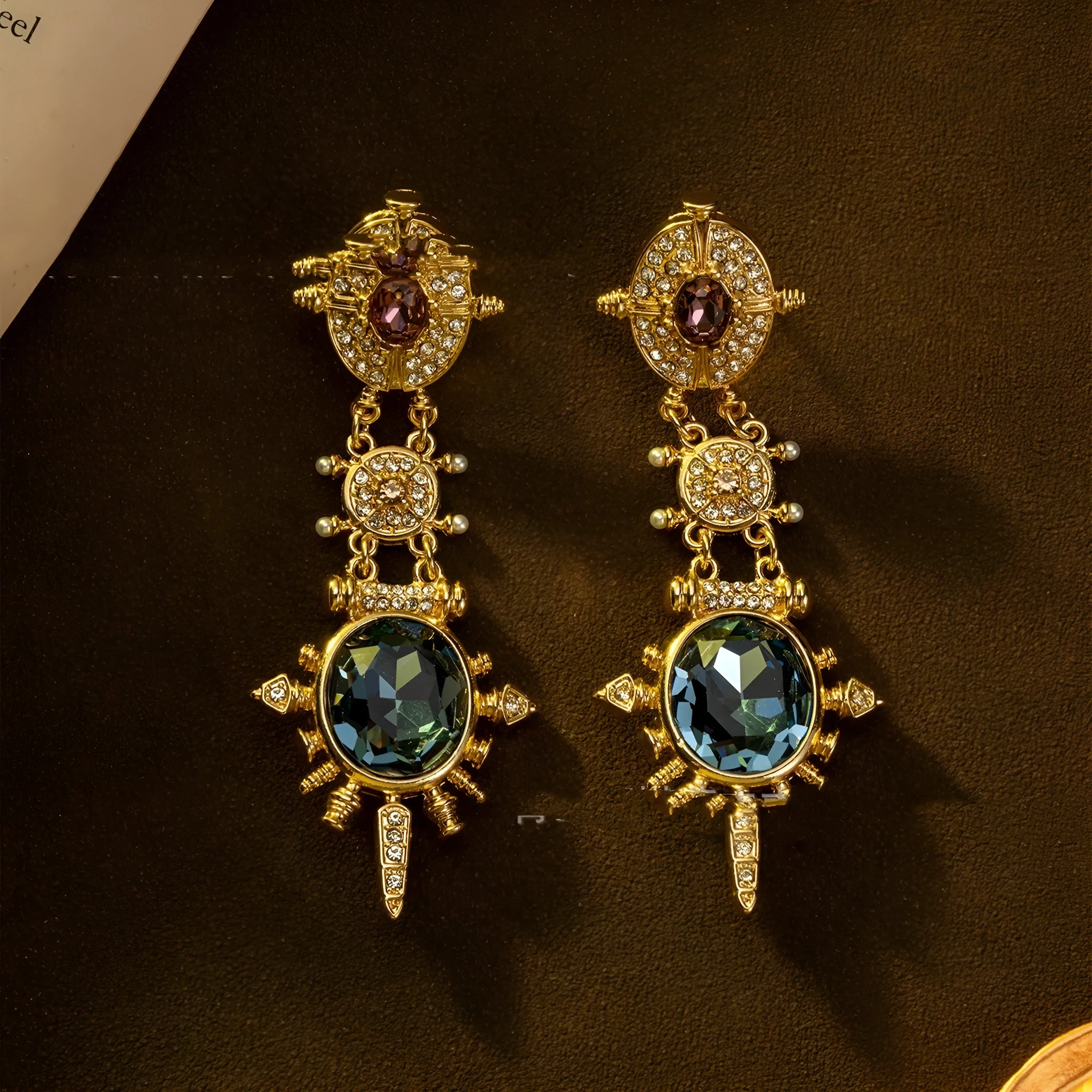 A pair of gold retro-style stud earrings with a geometry shape and round design elements.
