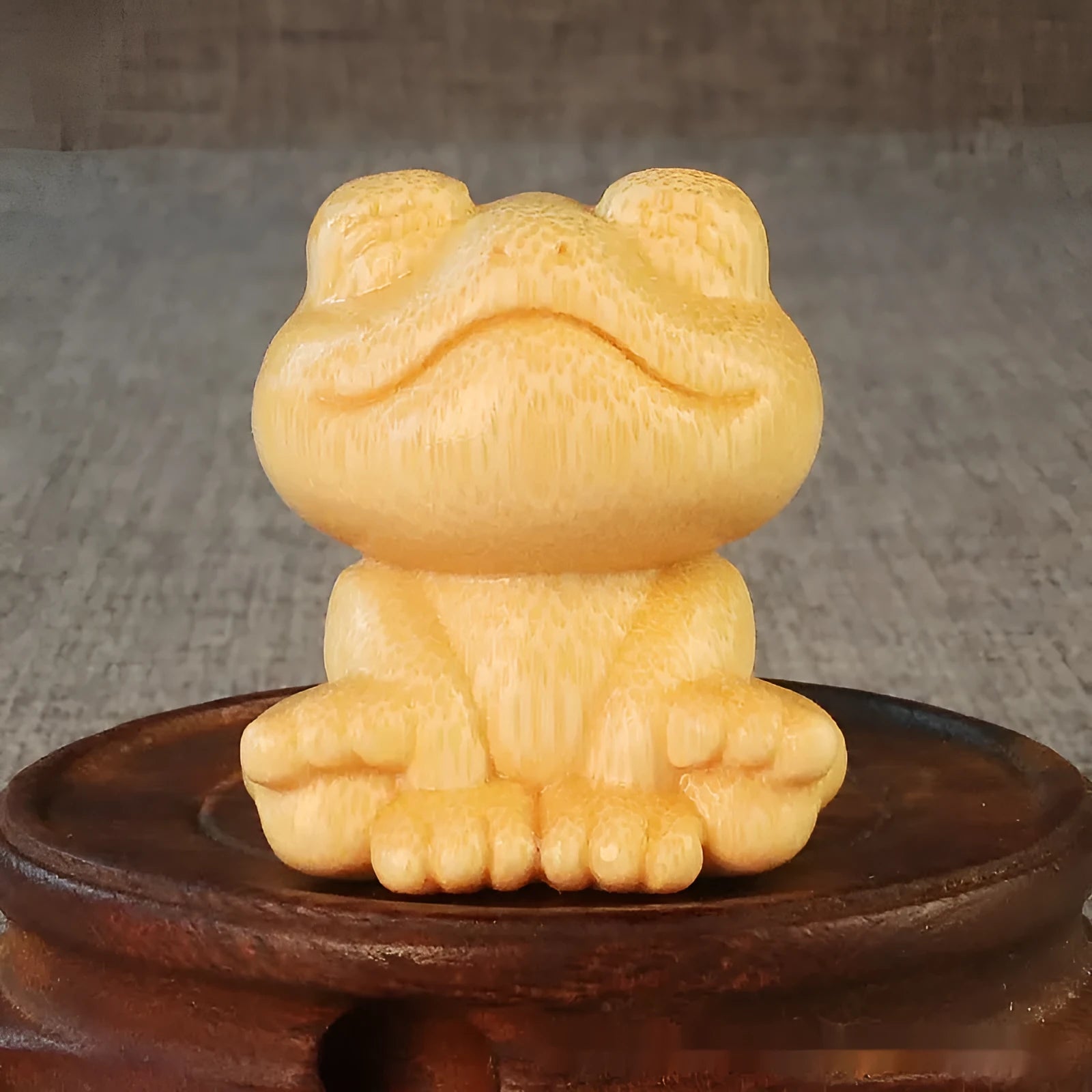 Solid bamboo smiling frog carving ornament measuring 5cm high with cartoon design