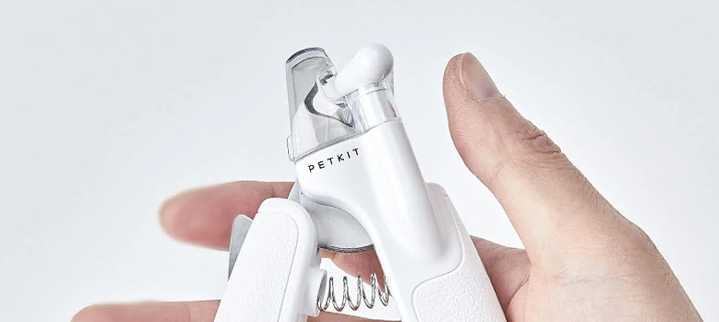 White LED pet nail clippers with a transparent guard open, showing the triangular blade and integrated nail file.