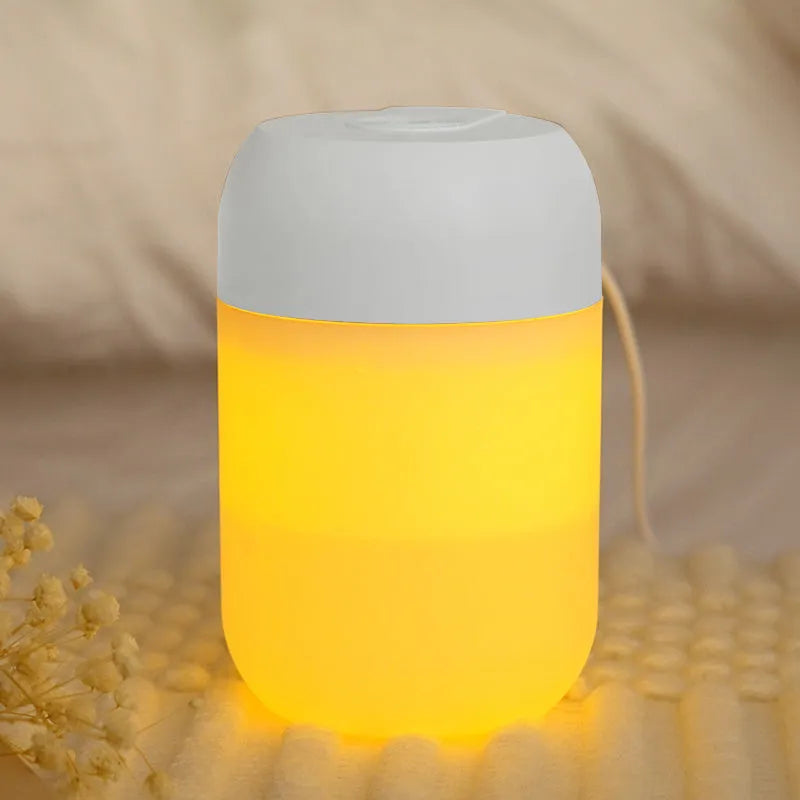 White cylindrical USB mini humidifier with mist output and charging cable