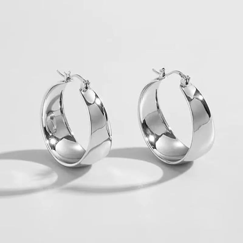 Widened curved stainless steel earrings in gold or steel colour with 25mm and 30mm size options