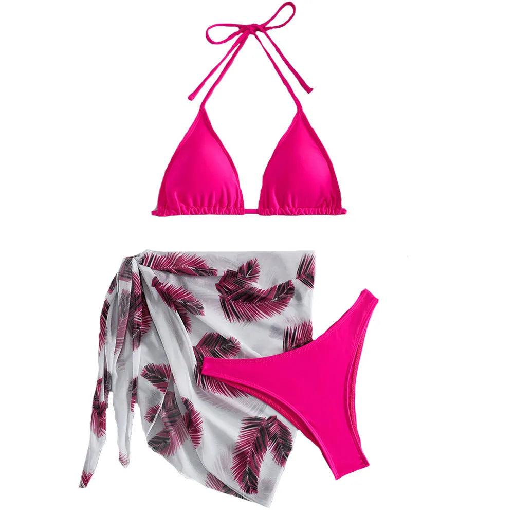Orange three-piece swimsuit set showing bikini top, bottom, and a loose printed gauze skirt on a mannequin.