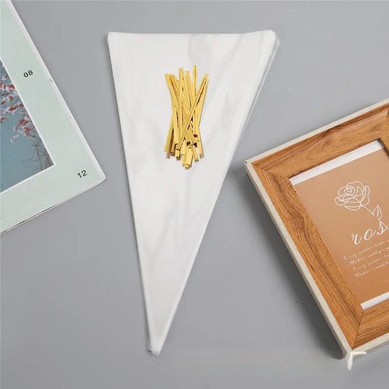 Clear triangle-shaped plastic packaging bag with a twisted top secured by a white tie wire.