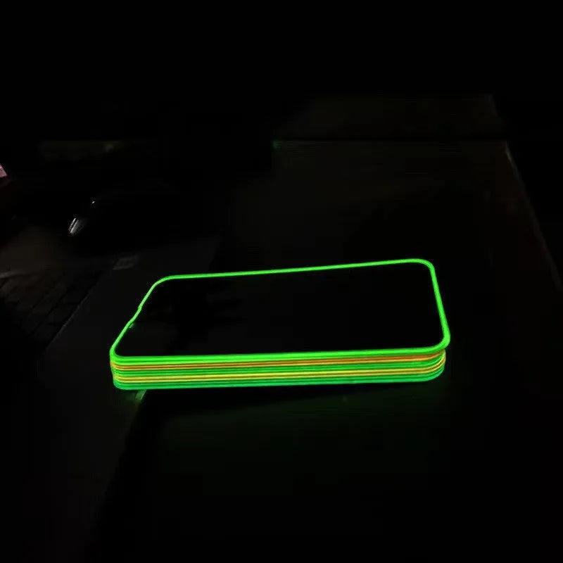 Fluorescent pink tempered glass screen protector glowing on an iPhone 13 Pro Max.