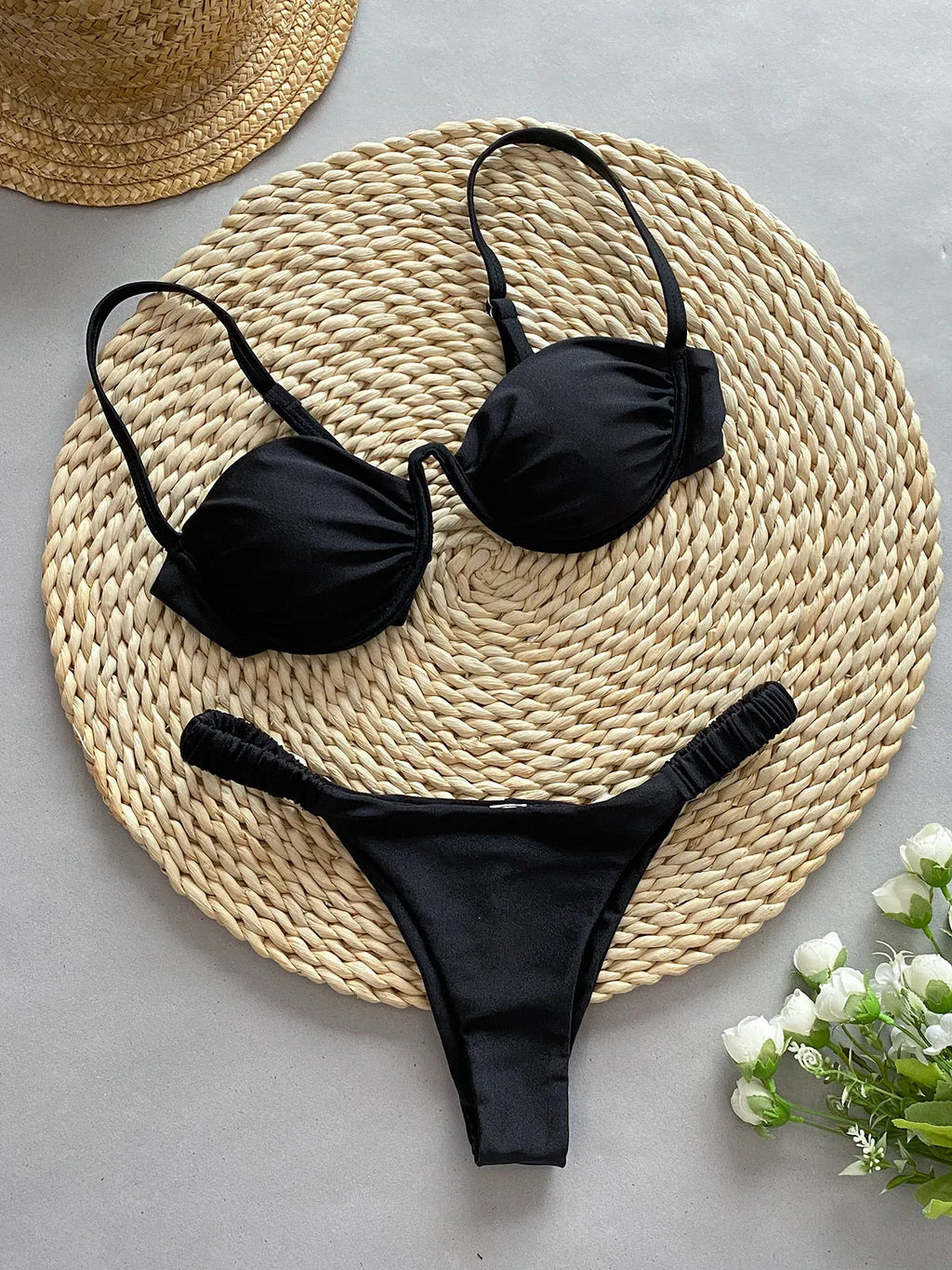 Women's black underwire bikini swimsuit set with split briefs on a mannequin.