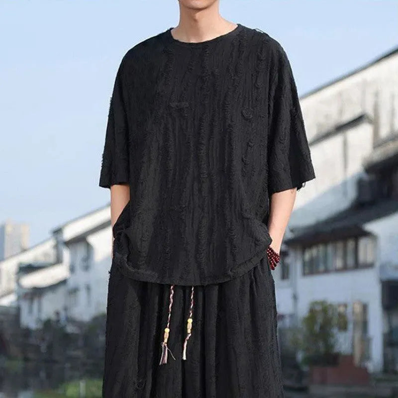 Men's loose two-piece summer suit set with thin short-sleeved top and cropped trousers in black or grey
