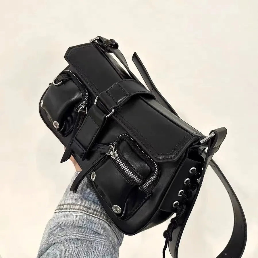 Black women's underarm baguette bag with adjustable shoulder strap showing internal zippered change compartment