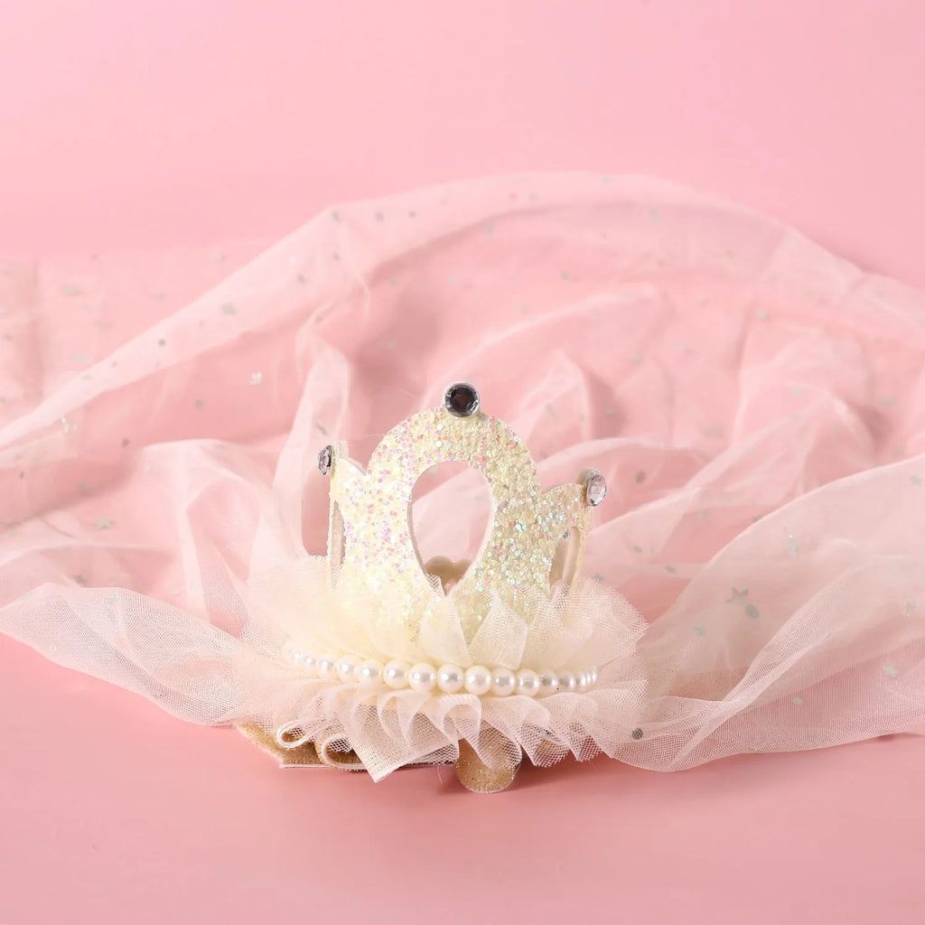 Pet cat wearing princess crown headdress with veil for wedding or celebration