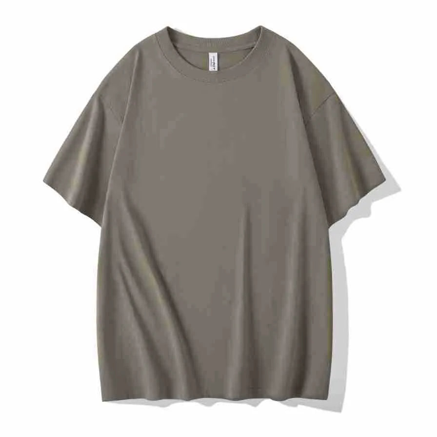 Man wearing a heavyweight dark grey drop shoulder T-shirt with layered shoulder detail.