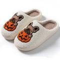 Black and white Halloween plush slippers with pumpkin pattern and non-slip rubber soles.