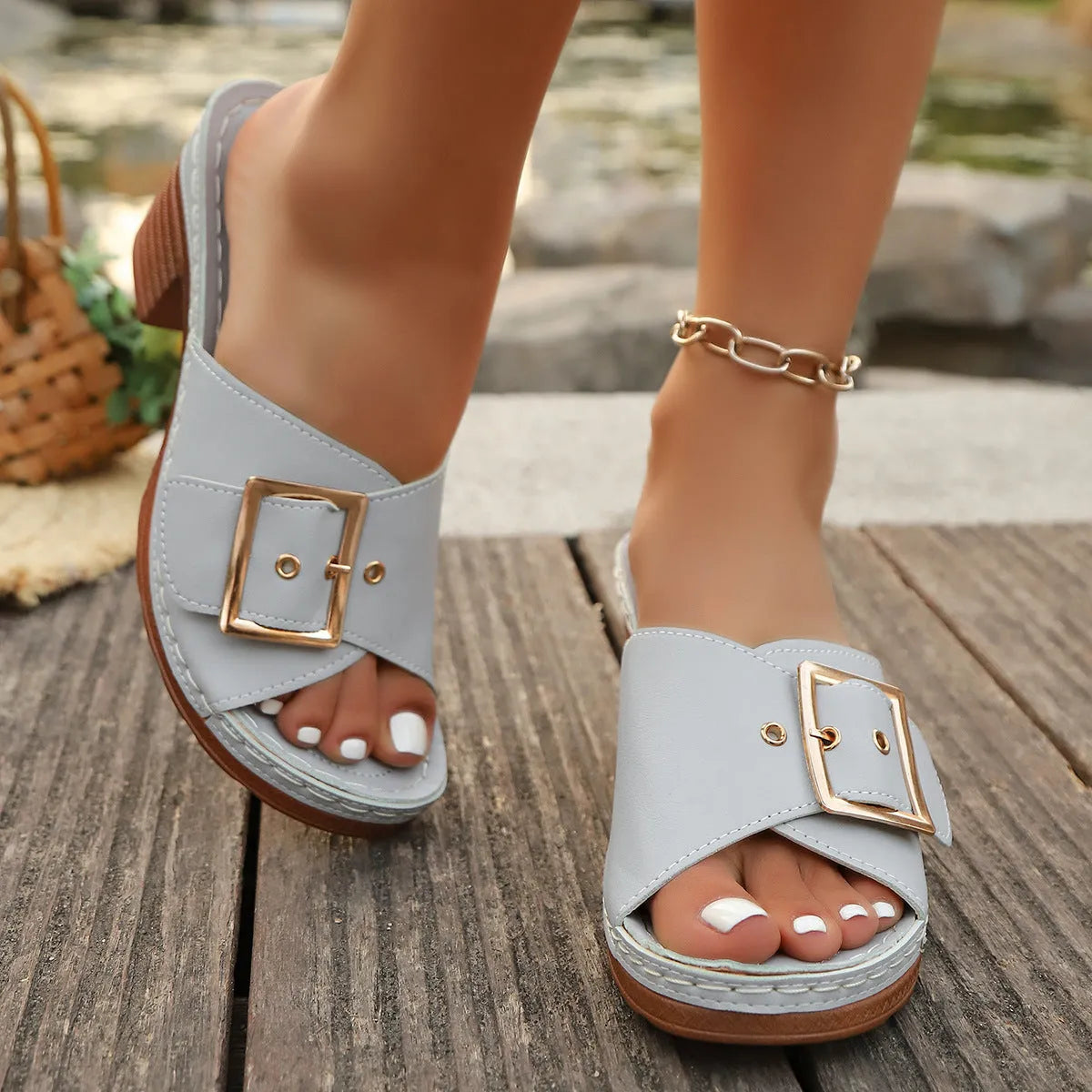 Women's black chunky heel slippers with a silver metal buckle and a round toe.