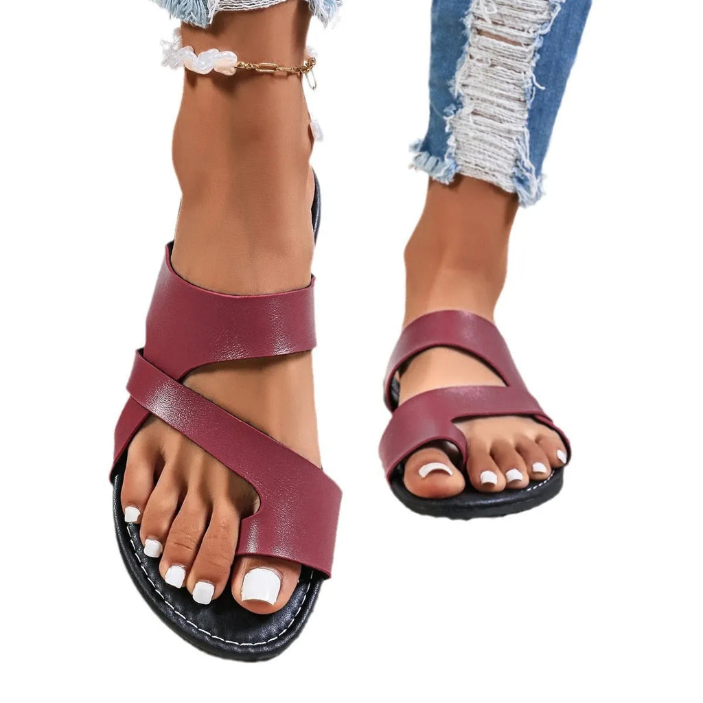 Round-toe beach slippers with hollow-out design in black, brown, and wine red colours.