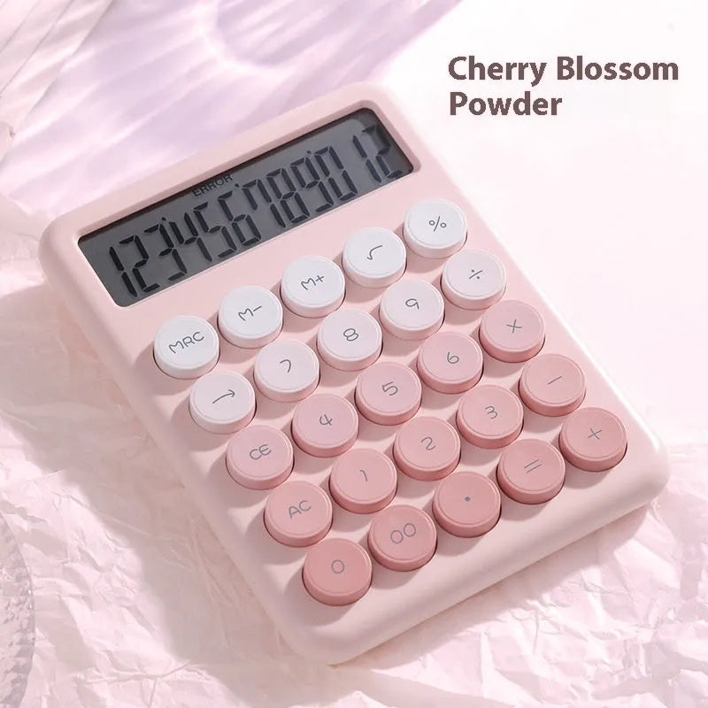 Gradient colour desk calculator in violet, pink, blue, or mint green on a desk.