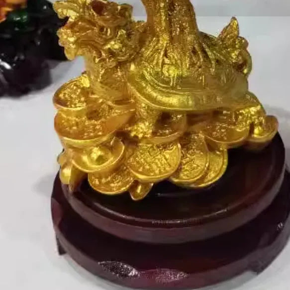 Citrine coloured resin turtle money tree Chinese style ornament on display.