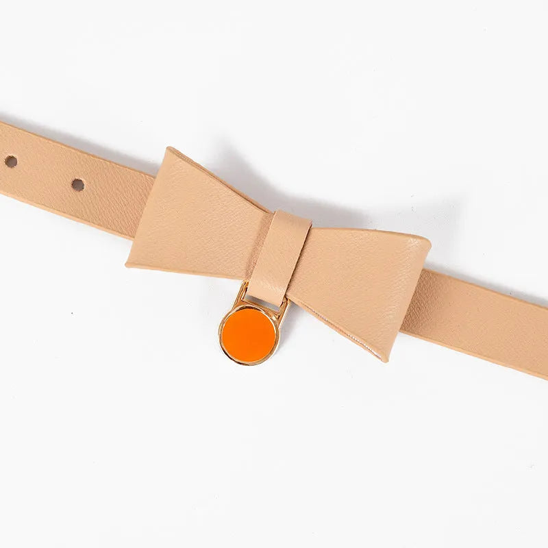 Adjustable brown leather cat collar with a metal buckle on a flat surface.